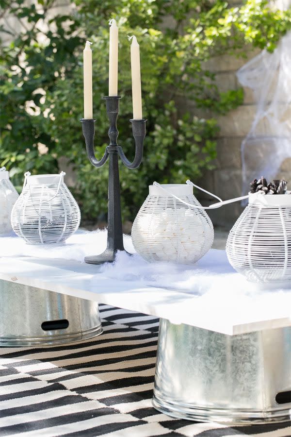 <p>You may not have a giant candelabra on hand, but you probably have some summer lanterns (and you can always just use smaller candelabras). <a href="https://www.housebeautiful.com/entertaining/holidays-celebrations/g21753908/halloween-lanterns/" rel="nofollow noopener" target="_blank" data-ylk="slk:Refresh them for Halloween;elm:context_link;itc:0;sec:content-canvas" class="link ">Refresh them for Halloween</a> by filling them up with candy and placing them on top of faux spiderwebs. See more at <a href="https://sugarandcharm.com/2013/10/kids-halloween-party-ideas.html?section-5" rel="nofollow noopener" target="_blank" data-ylk="slk:Sugar and Charm;elm:context_link;itc:0;sec:content-canvas" class="link ">Sugar and Charm</a>.</p><p><a class="link " href="https://go.redirectingat.com?id=74968X1596630&url=https%3A%2F%2Fwww.anthropologie.com%2Fshop%2Fpunched-iron-solar-lantern%3Fcolor%3D010%26size%3DOne%2BSize%26inventoryCountry%3DUS%26countryCode%3DUS%26creative%3D518892611960%26device%3Dc%26network%3Dg%26gclid%3DCjwKCAjwqvyFBhB7EiwAER786Z9fXJSA2c9pCPV2sRJl_Zy7sK967M53F0D6EIgR-BuxfmFT5Rw11RoCD5gQAvD_BwE%26gclsrc%3Daw.ds%26type%3DSTANDARD%26quantity%3D1&sref=https%3A%2F%2Fwww.housebeautiful.com%2Fentertaining%2Fholidays-celebrations%2Fg2554%2Fhalloween-decorations%2F" rel="nofollow noopener" target="_blank" data-ylk="slk:BUY NOW;elm:context_link;itc:0;sec:content-canvas">BUY NOW</a> <strong><em>Anthropologie Lantern, $24</em></strong></p>