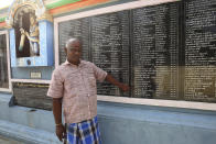 FILE - In this Nov. 3, 2020, file photo, a villager points out the name of Kamala Harris written in Tamil language and the amount she donated for the renovation of temple through her relative, in Thulasendrapuram village, south of Chennai, Tamil Nadu state, India. The lush green village is the hometown of Harris' maternal grandfather who migrated from there decades ago. (AP Photo/Aijaz Rahi, File)