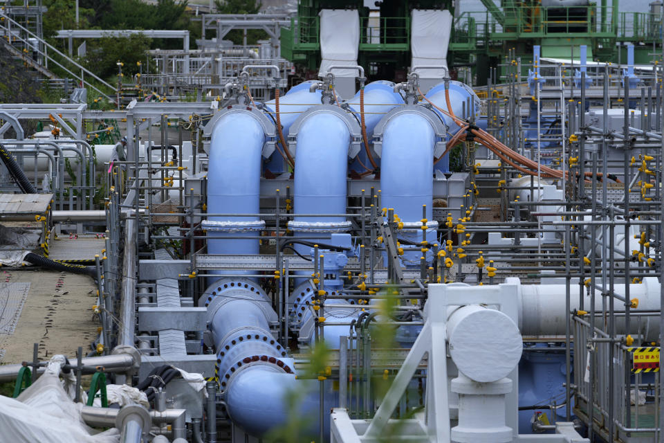 This photo taken during a tour for The Associated Press shows a blue pipeline to transport seawater, part of the facility for the release of treated radioactive water to sea from the Fukushima Daiichi nuclear power plant, operated by Tokyo Electric Power Company Holdings, also known as TEPCO, in Futaba town, northeastern Japan, Friday, July 14, 2023. (AP Photo/Hiro Komae)