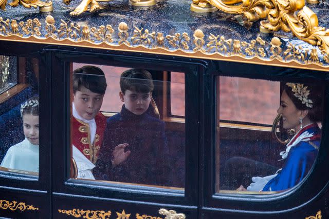 Adam Gerrard - WPA Pool/Getty From left: Princess Charlotte, Prince George, Prince Louis and Kate Middleton ride in a carriage after the coronation on May 6, 2023