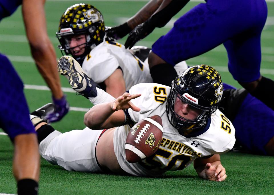 Stephenville offensive lineman Mason Butchee recovers a fumble during Friday's Class 4A Div. I state championship game against Austin's LBJ high school in Arlington Dec. 17, 2021.
