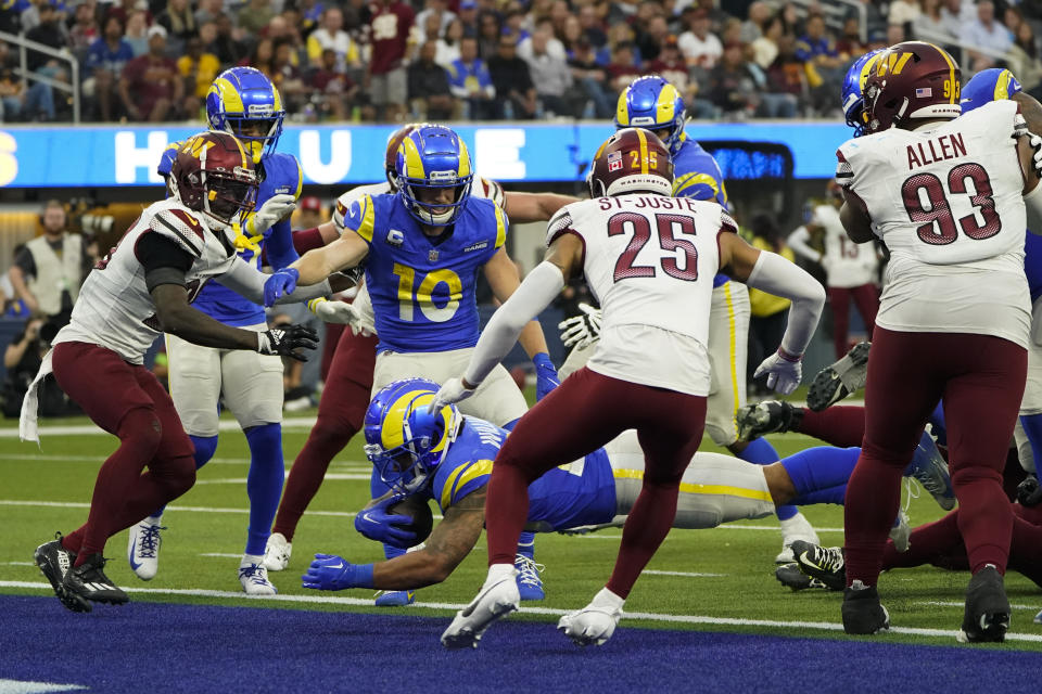 Los Angeles Rams running back Kyren Williams (23) scores a two-point conversion during the second half of an NFL football game against the Washington Commanders Sunday, Dec. 17, 2023, in Inglewood, Calif. (AP Photo/Marcio Jose Sanchez)