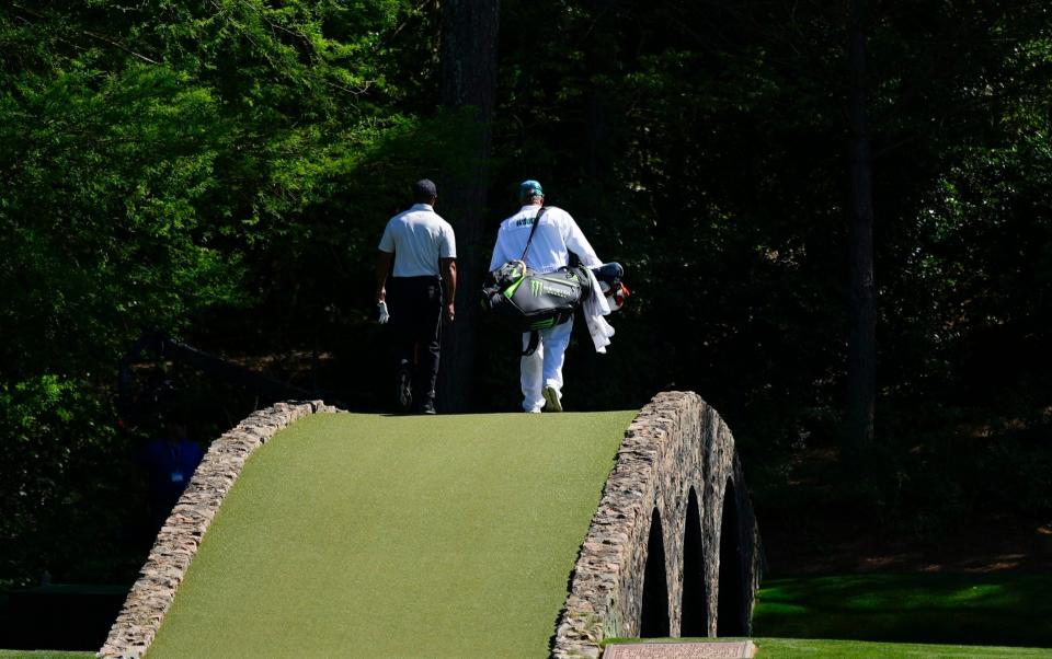 Tiger Woods walking over the Ben Hogan bridge