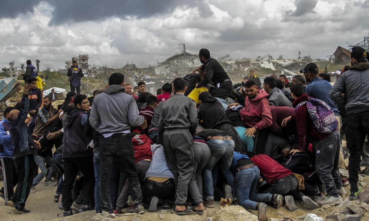 <span>Palestinians rush to the site of an aid airdrop on the Gaza coast last week.</span><span>Photograph: Anadolu/Getty Images</span>