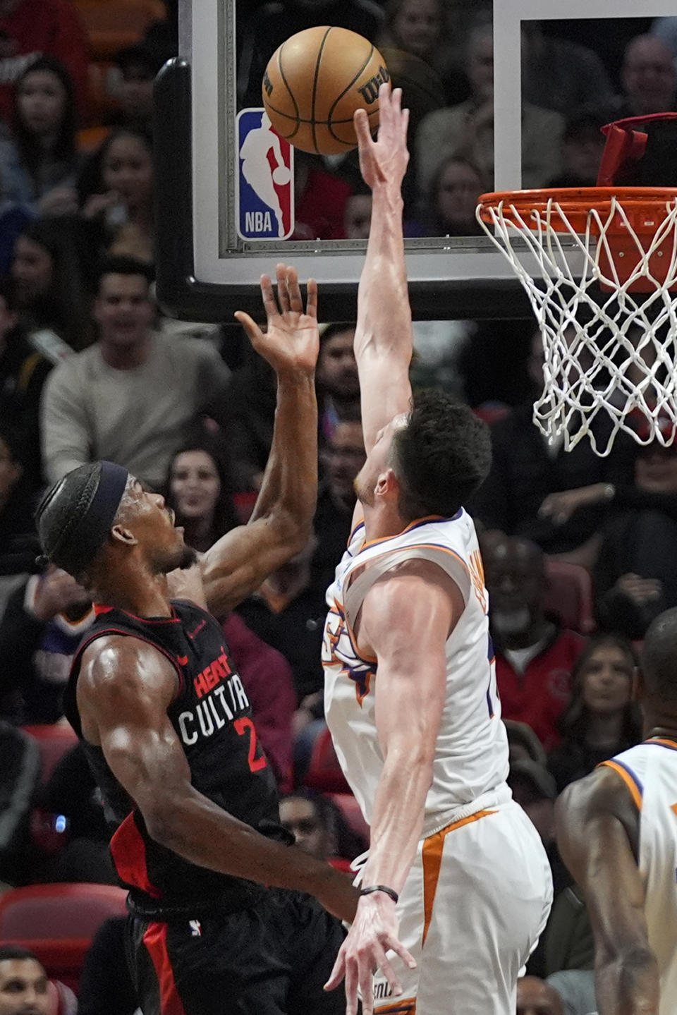 Phoenix Suns center Drew Eubanks, right, rejects a ball from Miami Heat forward Jimmy Butler during the first half of an NBA basketball game, Monday, Jan. 29, 2024, in Miami. (AP Photo/Wilfredo Lee)