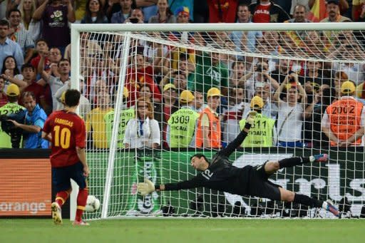 Spanish midfielder Cesc Fabregas (L) scores the winning penalty despite Portuguese goalkeeper Rui Patricio during the penalty shoot out of the Euro 2012 football championships semi-final match Portugal vs. Spain at the Donbass Arena in Donetsk