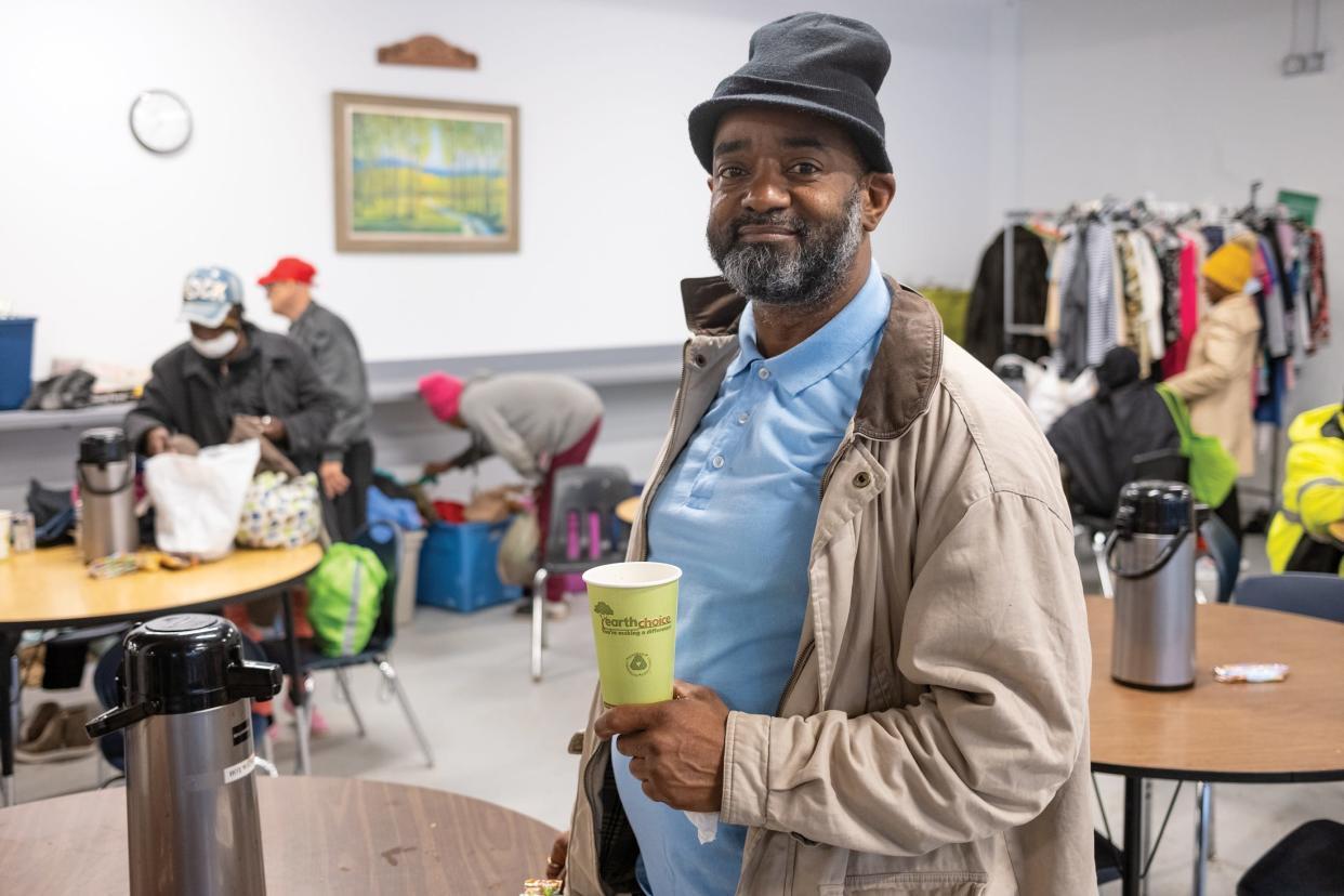 Shawn Brown smiles after a meal at the Open Shelter.
