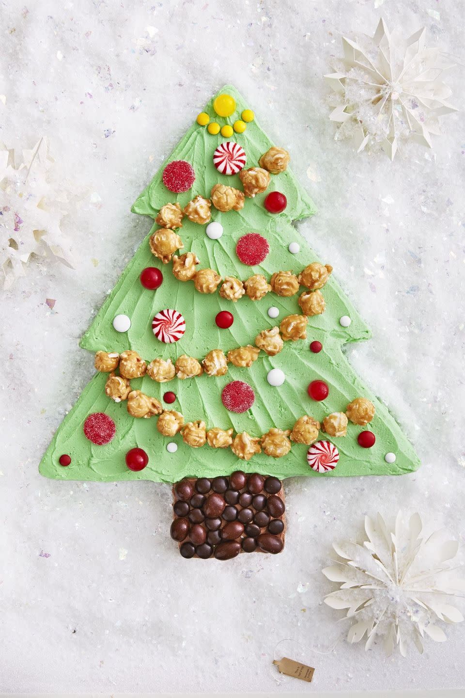 <p>Ornamental gumdrops, M&Ms, and starlight mints take shape around a caramel corn garland and a chocolate candy base. Colorful sprinkles in the batter give this cake a second helping of whimsy.</p><p><strong><a href="https://www.countryliving.com/food-drinks/recipes/a40521/christmas-tree-sheet-cake-recipe/" rel="nofollow noopener" target="_blank" data-ylk="slk:Get the recipe for Christmas Tree Sheet Cake;elm:context_link;itc:0;sec:content-canvas" class="link ">Get the recipe for Christmas Tree Sheet Cake</a>.</strong></p>
