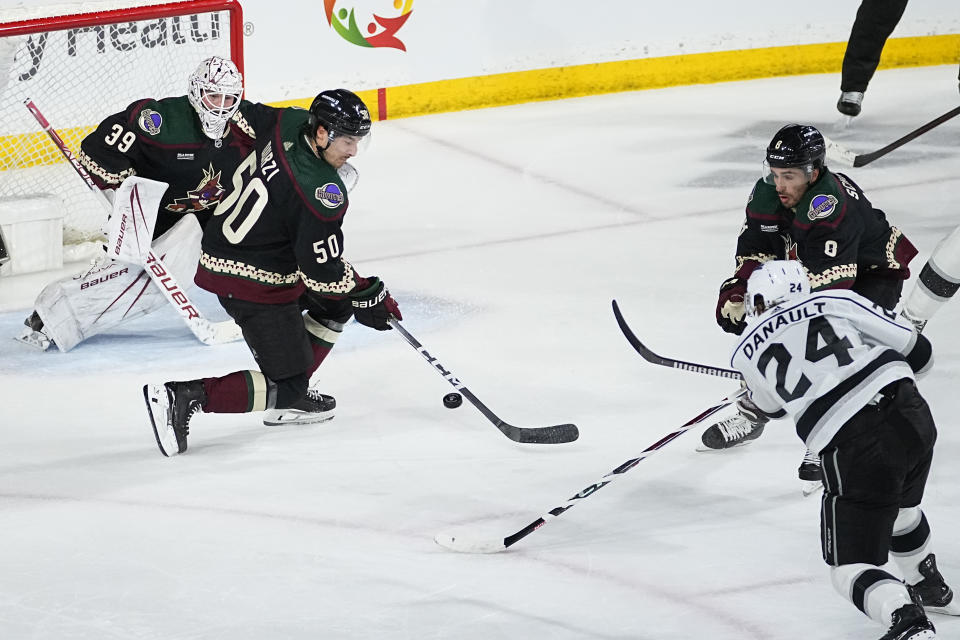 Los Angeles Kings center Phillip Danault (24) scores a goal on Arizona Coyotes goaltender Connor Ingram (39) during the third period of an NHL hockey game, Monday, Nov. 20, 2023, in Tempe, Ariz. (AP Photo/Matt York)