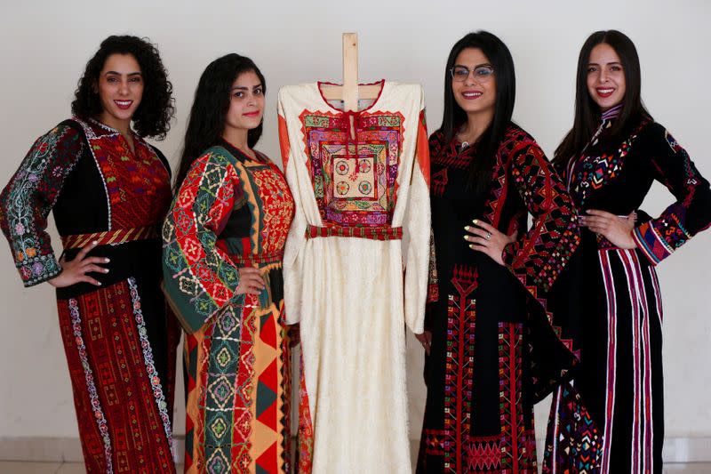 Models present traditional Palestinian dresses at Al Hanouneh society for popular culture in Amman