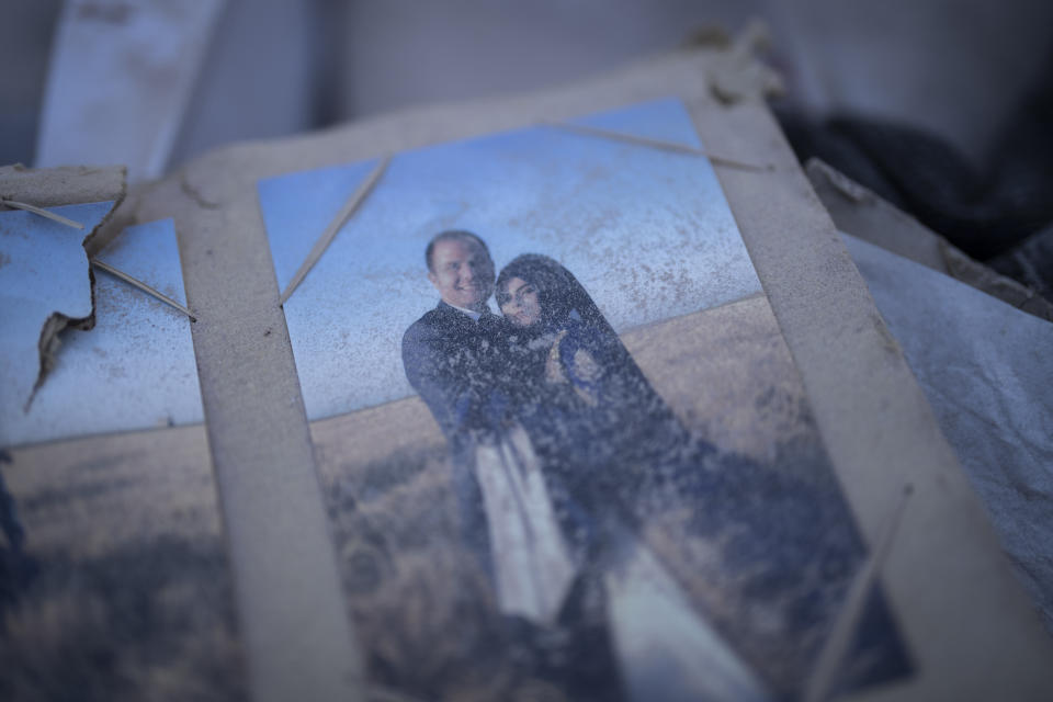 Dust covers a family photo album found among the debris of a building destroyed during the earthquake in Antakya, southeastern Turkey, Tuesday, Feb. 14, 2023. The death toll from the earthquakes of Feb. 6, that struck Turkey and northern Syria is still climbing. (AP Photo/Bernat Armangue)