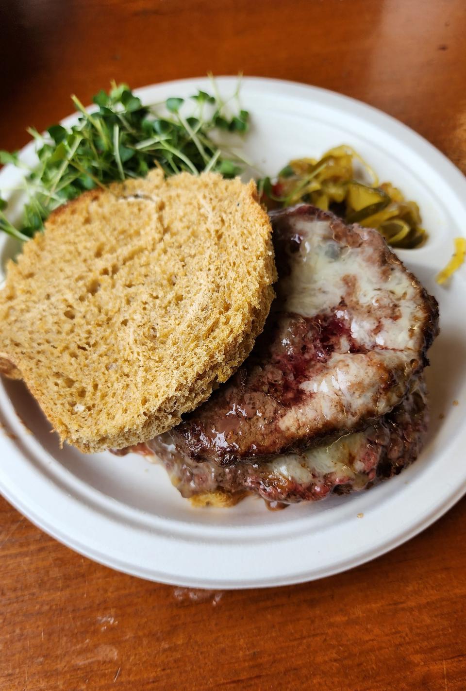 A burger at Nezinscot Farm Cafe comes with housemade pickles, bread and cheese and greens and beef grown on the farm.