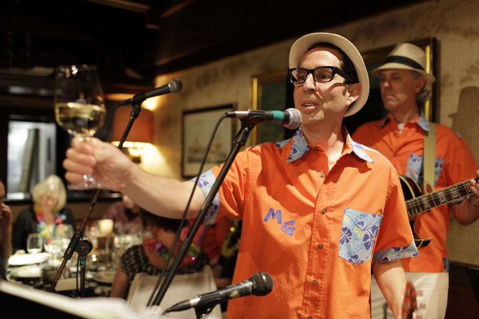 In this photo taken Friday, March 23, 2012, winemaker Judd Finkelstein of Judd's Hill winery, makes a toast before playing his ukulele with his band during a winery luau at Trader Vic's restaurant in Emeryville, Calif. Don’t be surprised if Finkelstein serenades you with a ukulele. Playing the uke is one of his passions, he performs with his group Maikai Gents featuring The Mysterious Miss Mauna Loa. (AP Photo/Eric Risberg)