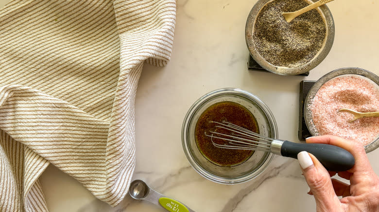 hand whisking the dressing