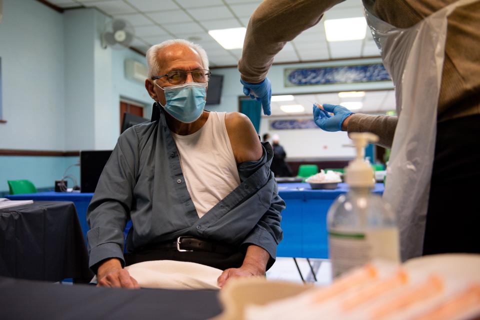 <p>Shoukatali Dahya, 80, receiving an injection of the Oxford/AstraZeneca coronavirus vaccine at the Al Abbas Mosque, Birmingham</p> (PA)