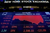 A screen displays trading information over the floor of the New York Stock Exchange (NYSE) in New York