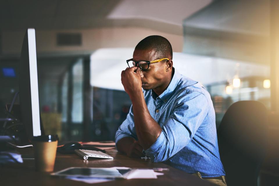 A man looking stressed in front of his computer