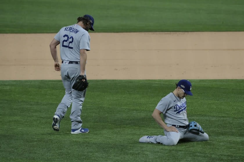 Dodgers pitcher Clayton Kershawand shortstop Enrique Hernandez fail to prevent an infield single against Atlanta on Thursday.