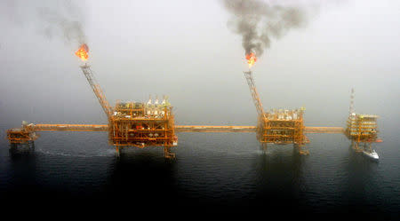 Gas flares from an oil production platform at the Soroush oil fields in the Persian Gulf, south of the capital Tehran, July 25, 2005. REUTERS/Raheb Homavandi/File Photo