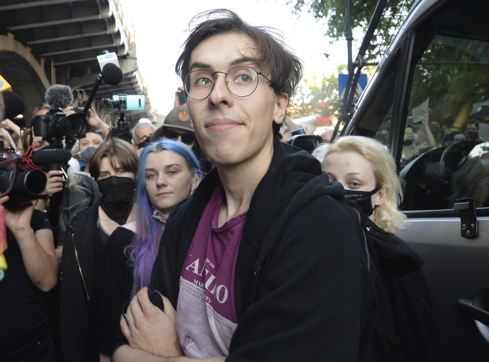 Activist Malgorzata Szutowicz, center, known as Margot, before being arrested in Warsaw, Poland, on Friday Aug. 7, 2020. LGBT rights activists scuffled with police Friday in Warsaw after turning out on the streets to protest the arrest of an an activist. According to Polish media reports, the activist was placed under two-months arrest Friday for protest actions against anti-homosexual attitudes. After the person was arrested in central Warsaw, protesters surrounded the police car and one person climbed on top of it. (AP Photo/Czarek Sokolowski)