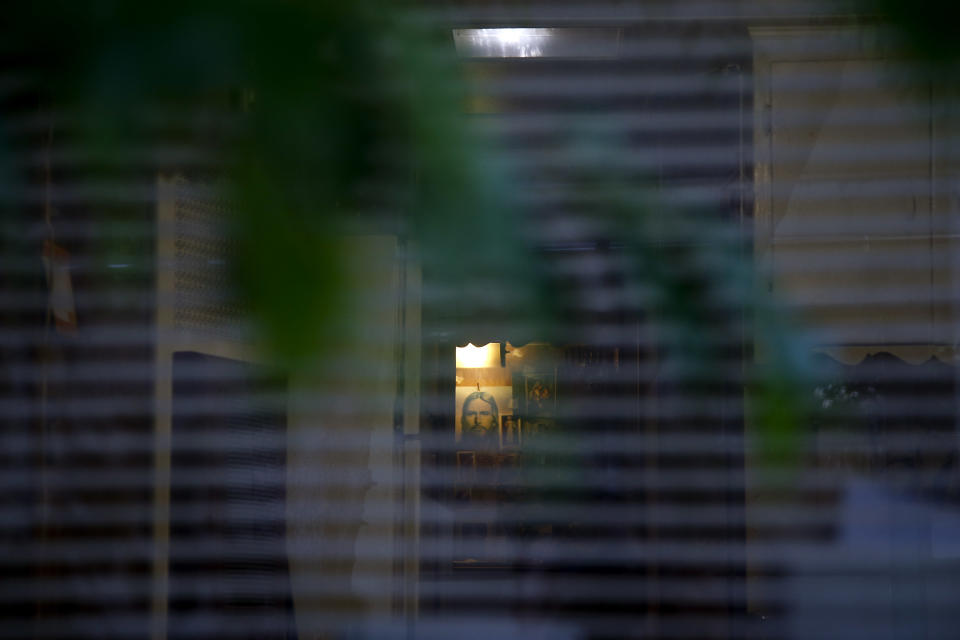 An image of Jesus is seen through a window of a mobile home at the Santa Monica Village Trailer Park in Santa Monica, Calif., Tuesday, July 10, 2012. The city's Planning Commission recently recommended the 3.8-acre park's zoning be changed to allow a developer to bulldoze its modest, rent-controlled homes and replace them with nearly 200 much-higher-priced apartments and condominiums, as well as more than 100,000 square feet of office and retail space. (AP Photo/Jae C. Hong)