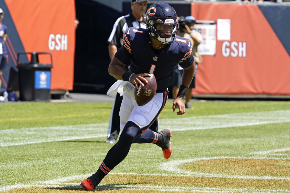 Chicago Bears quarterback Justin Fields runs with the ball during the first half of an NFL preseason football game against the Miami Dolphins in Chicago, Saturday, Aug. 14, 2021. (AP Photo/Nam Y. Huh)