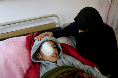 Lamia Abu Harb sits next to her sone Mohammad An-Najjar, 12, who was wounded in his eye during a protest at the Israel-Gaza border fence, in Khan Younis, in the southern Gaza Strip, January 13, 2019. REUTERS/Ibraheem Abu Mustafa