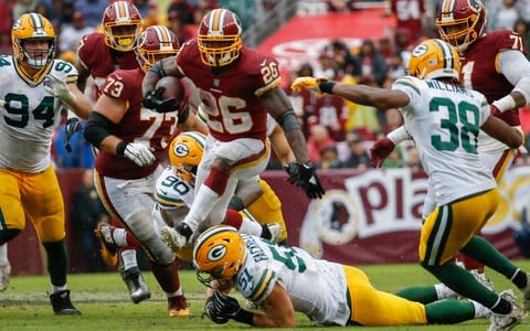 Washington Redskins running back Adrian Peterson (26) leaps over Green Bay Packers linebacker Kyler Fackrell (51) during the second half of an NFL football game - Credit: (AP Photo/Alex Brandon)