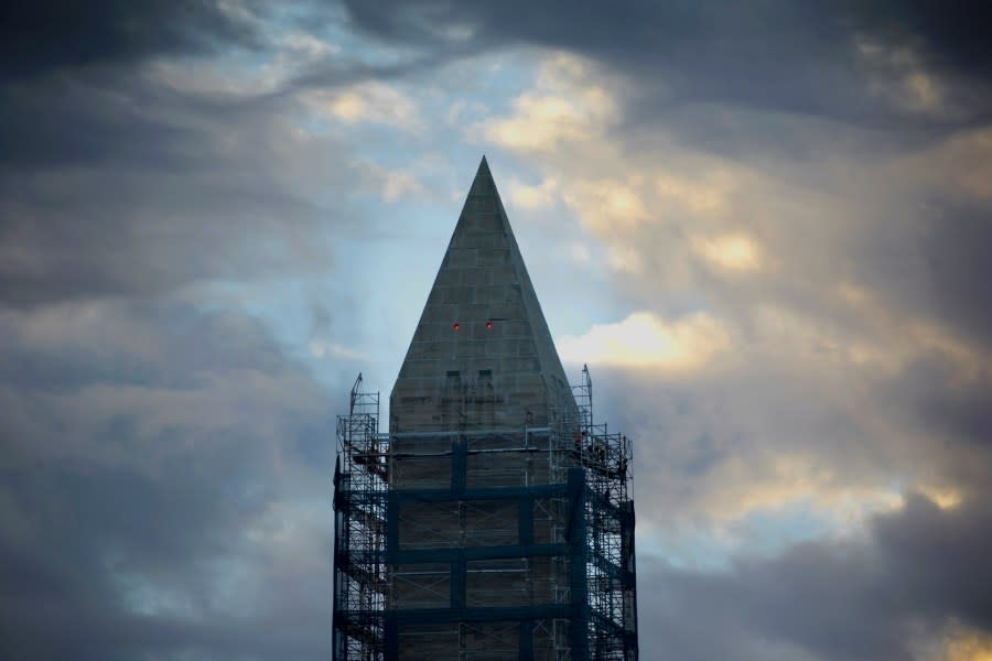 Work crews continue removing the scaffolding surrounding the Washington Monument in Washington, early Monday, Nov. 18, 2013. The National Park Service has announced the earthquake damaged monument will reopen in spring of 2014. (AP Photo/Pablo Martinez Monsivais)