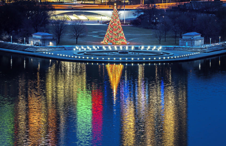 The Christmas tree at Point State Park in downtown Pittsburgh is illuminated at dawn on Christmas Eve, Friday, Dec. 24, 2021. (Andrew Rush/Pittsburgh Post-Gazette via AP)