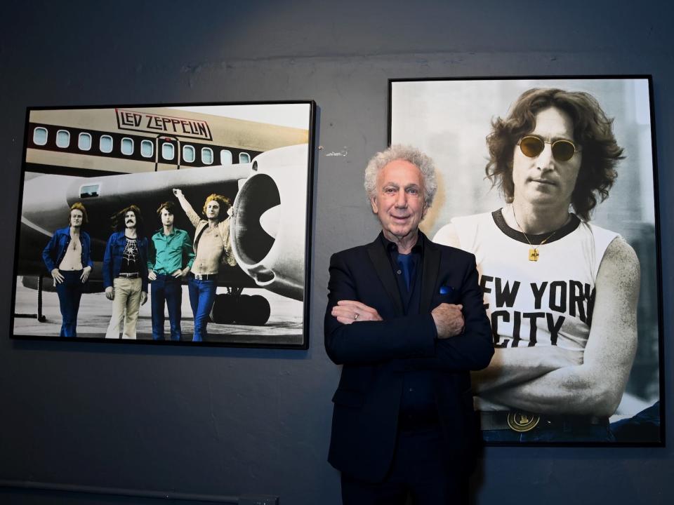 Bob Gruen poses with his photographs of John Lennon and Led Zeppelin during "Punk, Myths + Legends" Private Viewing in July 2022 in London.