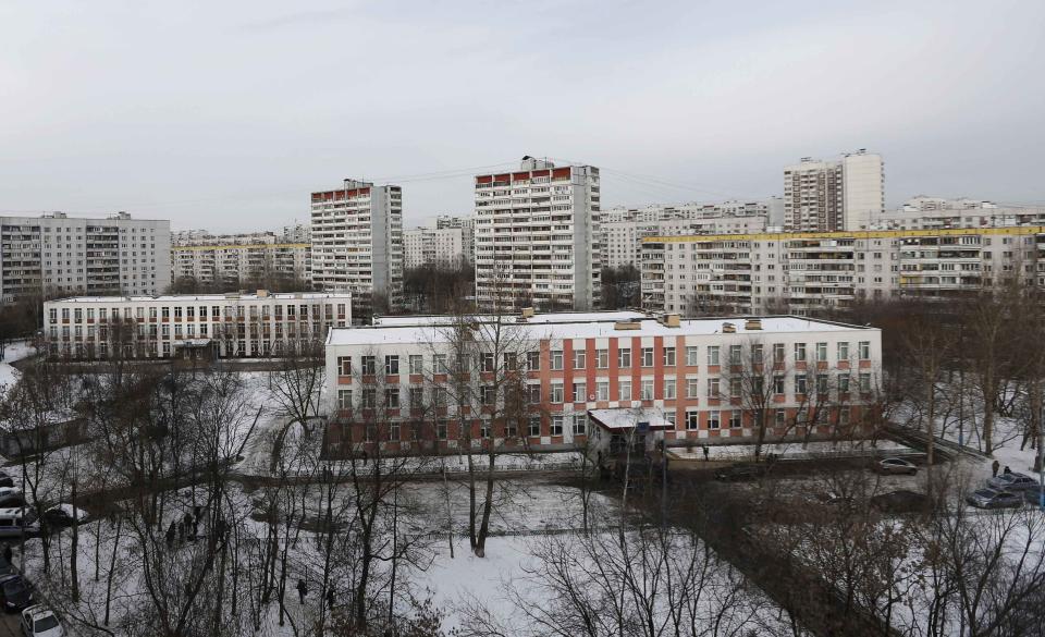 An aerial view shows a high school building (R), where a student shot a teacher and a police officer dead and held more than 20 other students hostage, on the outskirts of Moscow, February 3, 2014. The student was disarmed and detained, police said, just days before Russia hosts the Winter Olympics. (REUTERS/Maxim Shemetov)