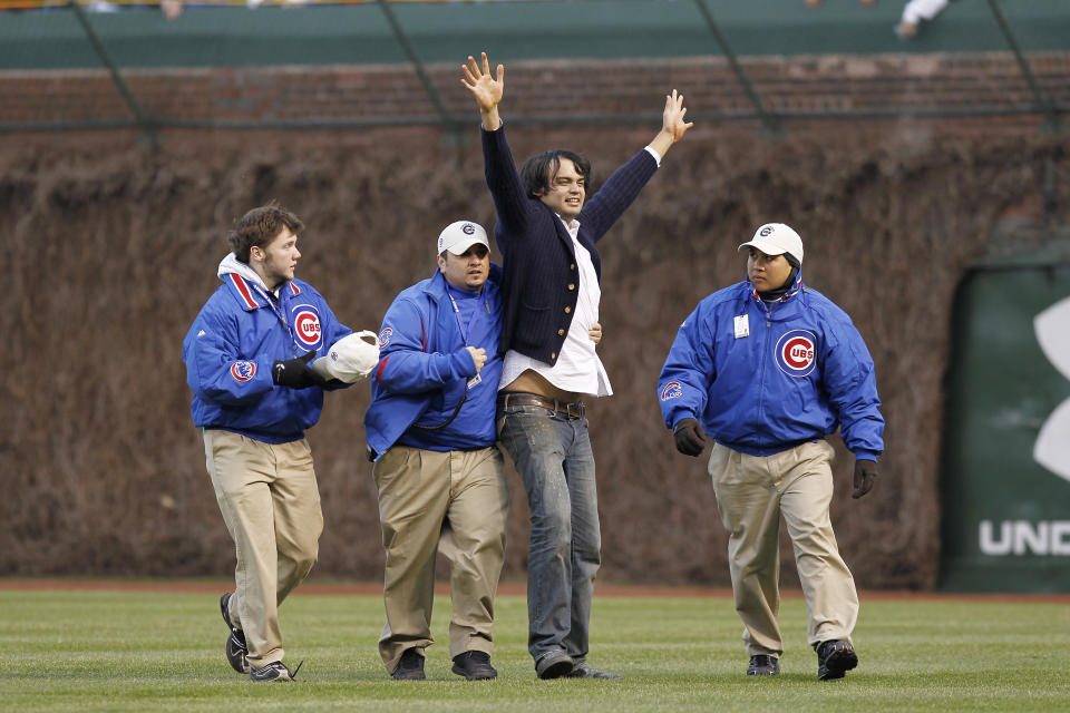 Chicago Cubs security personnel try to contain an unruly fan that ran onto the field during the game against the Arizona Diamondbacks at Wrigley Field on April 4, 2011 in Chicago, Illinois. The Cubs defeated the Diamondbacks 4-1. (Photo by Joe Robbins/Getty Images)
