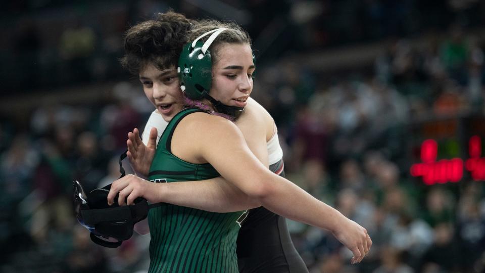 Cherry Hill East's Maya Hemo, left, and Kinnelon's Kayla Vazquez hug after Vazquez won the 132 lb. girls championship bout of the NJSIAA individual wrestling championships tournament at Jim Whelan Boardwalk Hall in Atlantic City on Saturday, March 4, 2023.