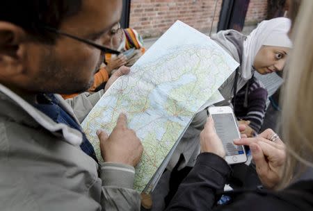 A migrant checks a map of Sweden after arriving at Malmo train station in Sweden in this September 10, 2015 file photo. Even Sweden has its limits. A self-proclaimed "humanitarian superpower" where welcoming those fleeing war and oppression is ingrained as part of the national identity, the Nordic country has proudly taken in more refugees per capita than any other in Europe. But now, with military barracks, ski lodges and camping huts already filling up, it is running of roofs to put over the heads of immigrants. The government is warning that tens of thousands of people may end up spending the Nordic winter in tents. REUTERS/Ola Torkelsson/TT News Agency/Files