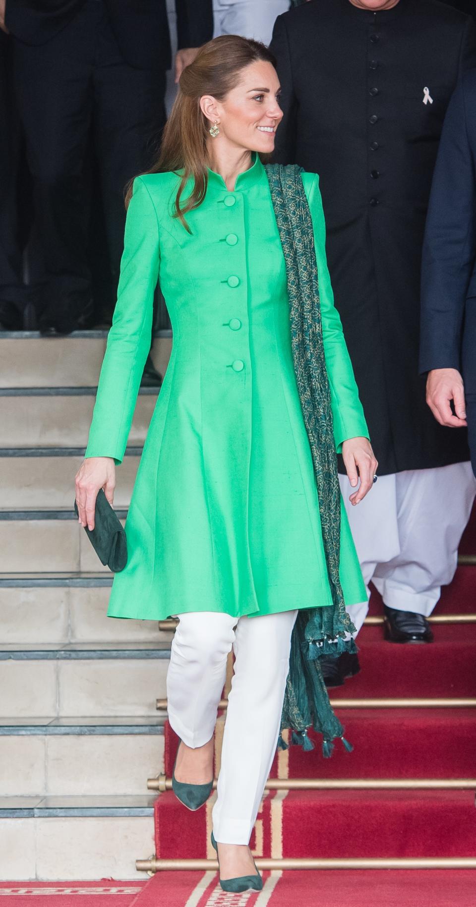For her and Prince William's meeting with Prime Minister Imran Khan, Middleton changed into a green tunic top by Catherine Walker, white pants by Maheen Khan, a <a href="https://www.bonanzasatrangi.com/row/lssbd-167-green-green-chiffon-dupatta" rel="nofollow noopener" target="_blank" data-ylk="slk:Bonanza Sarangi scarf;elm:context_link;itc:0;sec:content-canvas" class="link ">Bonanza Sarangi scarf</a>, and a dark green clutch and heels.