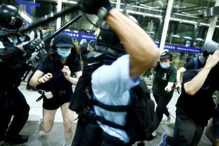 FILE PHOTO: Police clash with anti-government protesters at the airport in Hong Kong