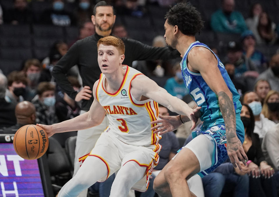 FILE - Atlanta Hawks guard Kevin Huerter (3) drives around Charlotte Hornets guard James Bouknight (5) during an NBA basketball game Sunday, Jan. 23, 2022, in Charlotte, N.C. The Atlanta Hawks are trading Kevin Huerter to the Sacramento Kings for Justin Holiday, Mo Harkless and a future conditional draft pick, according to a person with direct knowledge of the agreement. The person spoke to The Associated Press on condition of anonymity Friday, July 1, 2022, because the trade had not been formally approved by the NBA and announced by either club. (AP Photo/Rusty Jones, File)