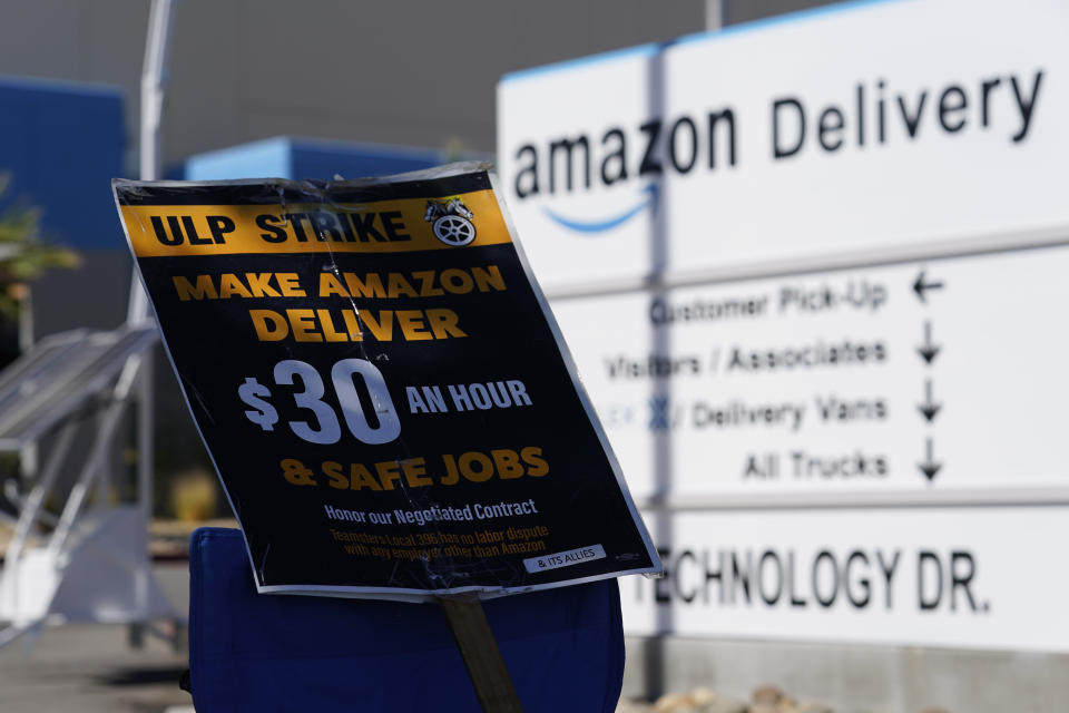A sign rests on a chair as workers who unionized with the Teamsters picket outside one of the Amazon's distribution centers on Monday, July 24, 2023, in Palmdale, Calif. Dozens of Amazon drivers and dispatchers who work for a California-based delivery firm the Teamsters unionized in April have been picketing company warehouses, calling on the e-commerce behemoth to come to the table and bargain over pay and working conditions. (AP Photo/Marcio Jose Sanchez)