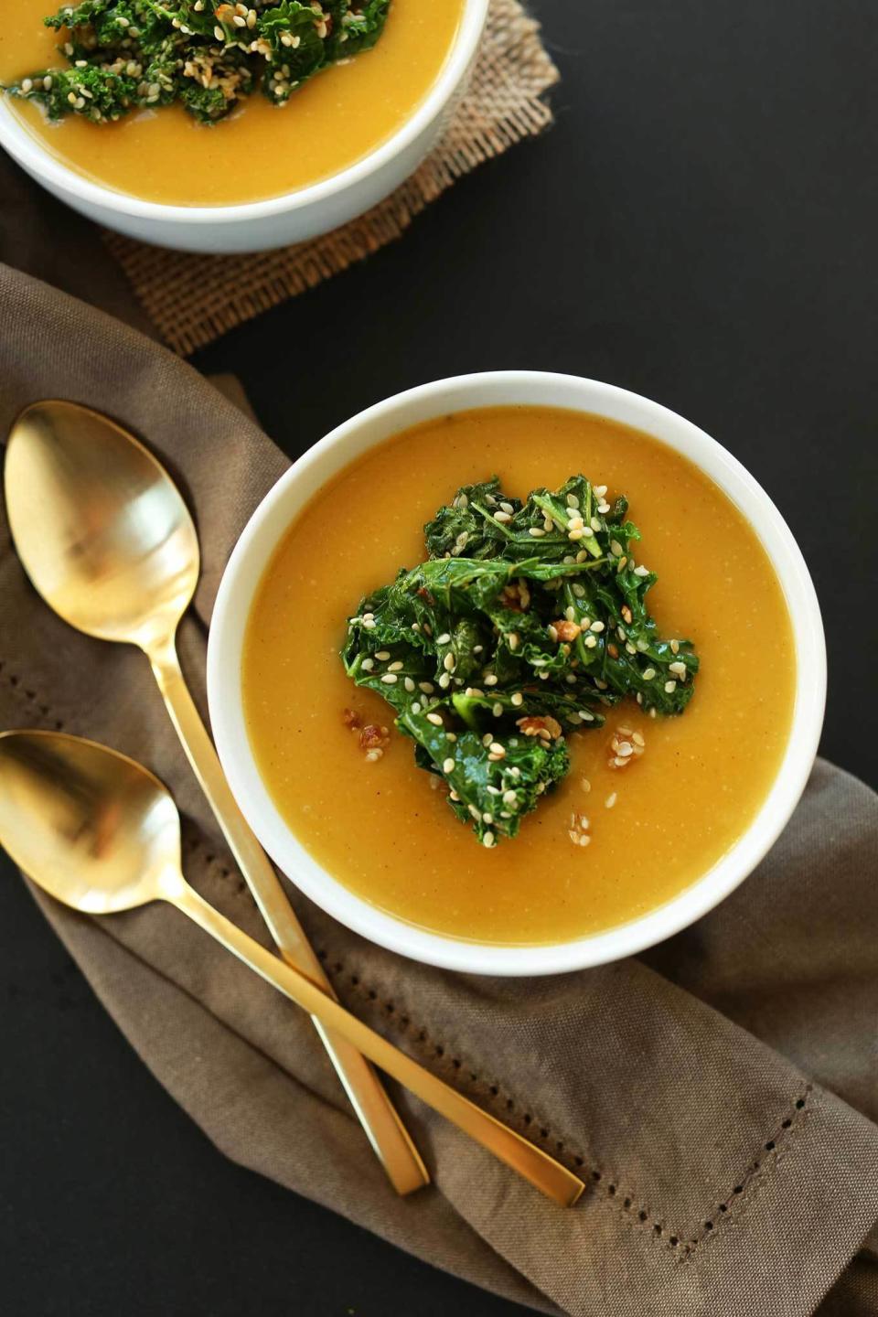 two bowls of the soup at a set dinner table