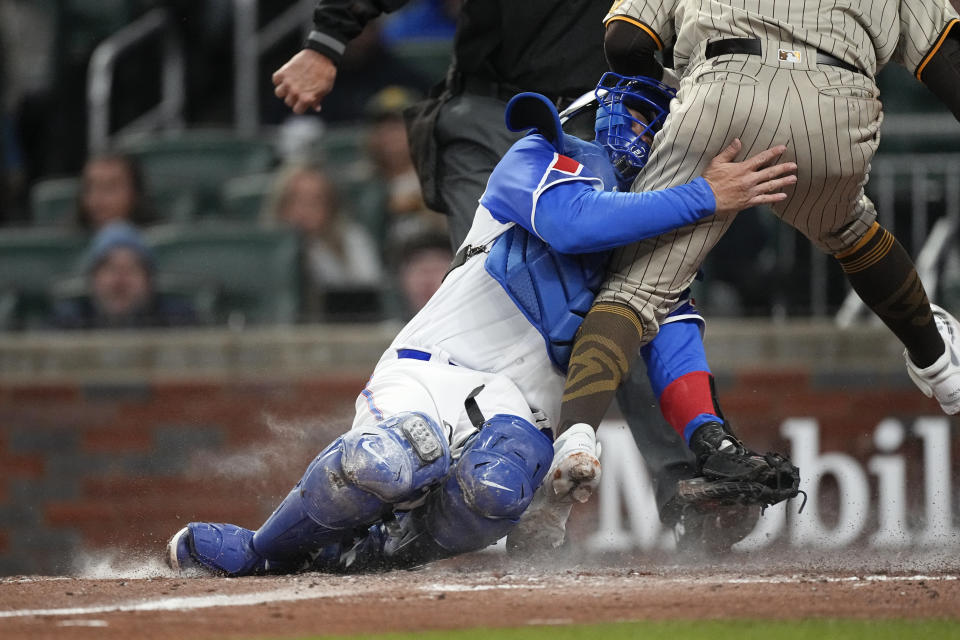 CORRECTS THAT ODOR WAS OUT, NOT SAFE - San Diego Padres' Rougned Odor (24) collides with Atlanta Braves catcher Travis d'Arnaud (16) as he is tagged out during the fourth inning of a baseball game Saturday, April 8, 2023, in Atlanta. (AP Photo/John Bazemore)