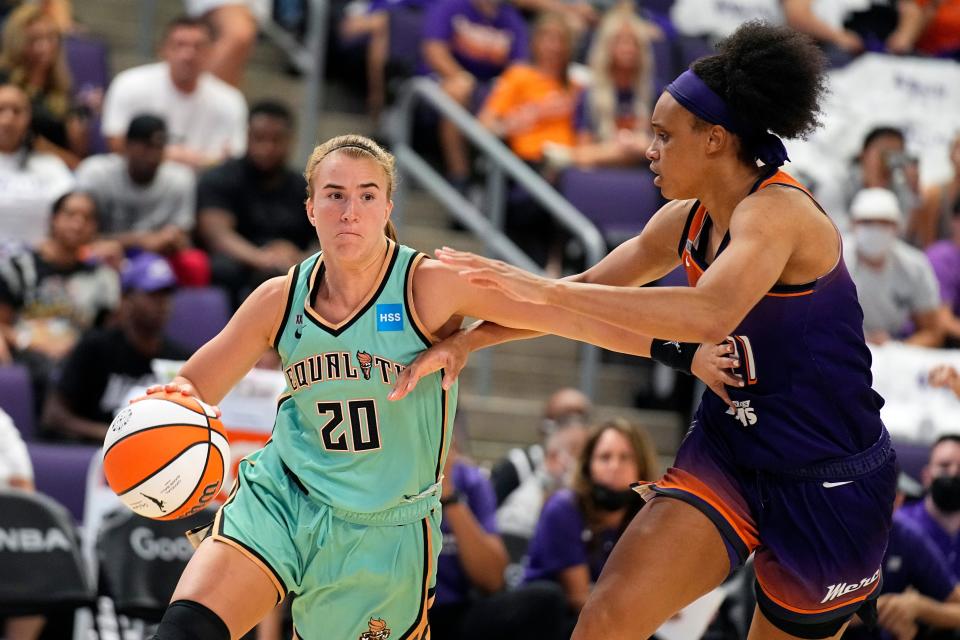 New York Liberty guard Sabrina Ionescu (20) drives on Phoenix Mercury forward Brianna Turner during the second half in the first round of the WNBA basketball playoffs, Thursday, Sept. 23, 2021, in Phoenix. Phoenix won 83-82. (AP Photo/Rick Scuteri)