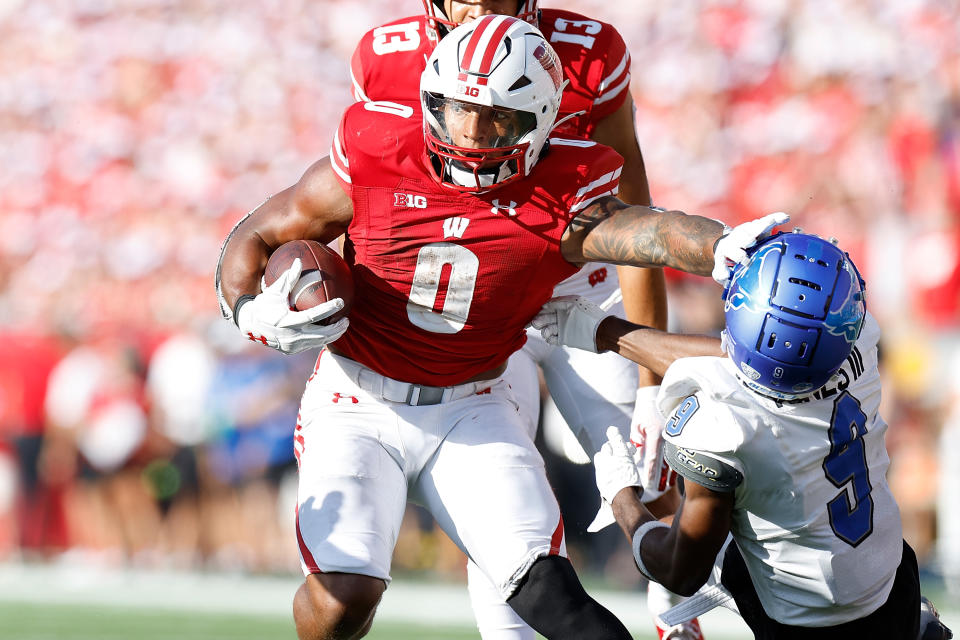 MADISON, WISCONSIN – SEPTEMBER 02: Braelon Allen #0 of the Wisconsin Badgers stiff arms Clevester Hines III #9 of the Buffalo Bulls on a 37 yard run in the third quarter against the Buffalo Bulls at Camp Randall Stadium on September 02, 2023 in Madison, Wisconsin. (Photo by John Fisher/Getty Images)