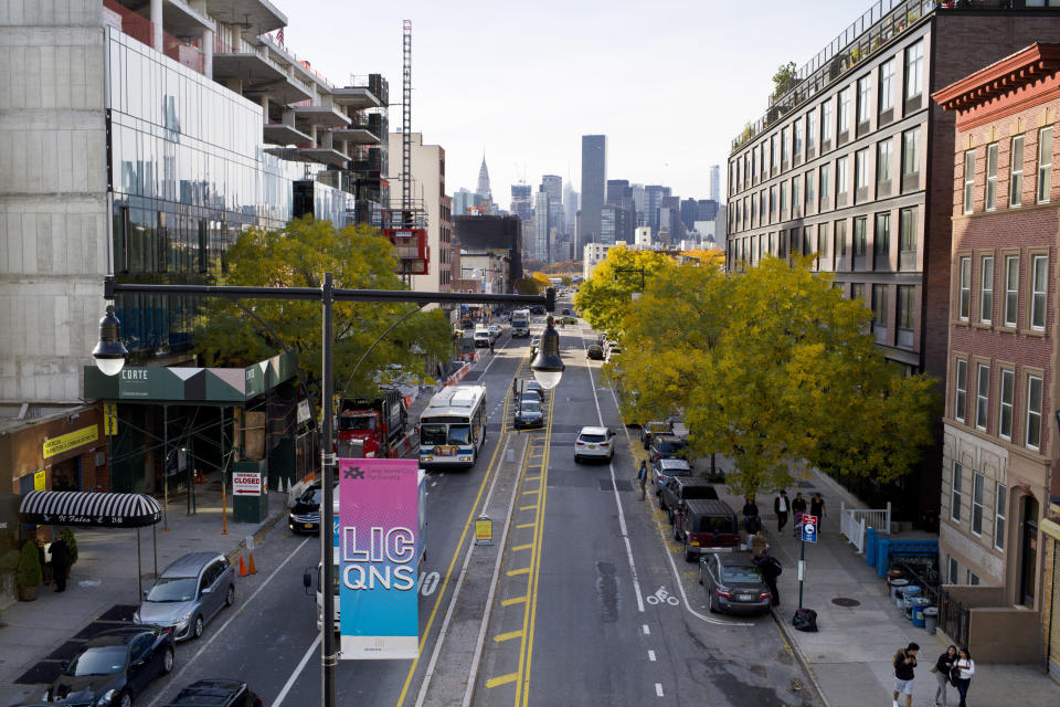 FILE- In this Wednesday, Nov. 7, 2018, file photo traffic moves along 44th Drive in Long Island City, in the Queens borough of New York. On Tuesday, Nov. 13, Amazon said it will split its second headquarters between Long Island City in New York and a suburb of Washington, in Arlington, Va. An expansion of that scope in a major city such as New York may seem like something a transit system could absorb. But some fear the addition of more commuters on already overcrowded roads and trains will just add to commuters’ headaches where Amazon makes its new homes. (AP Photo/Mark Lennihan, File)