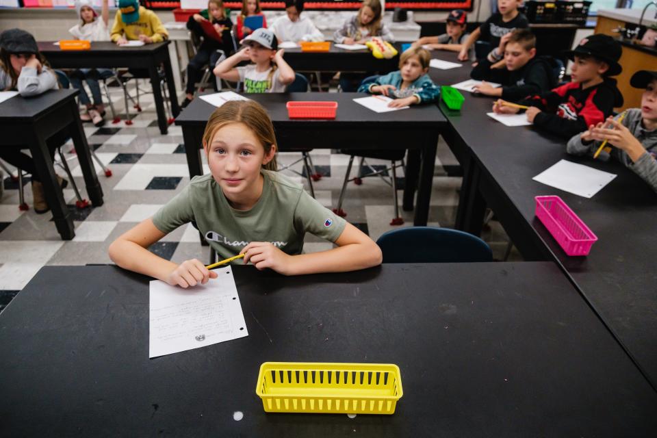 Addison Miller, who wants to be a news photographer, takes notes about how to create a newspaper during a special afterschool program at Tuscarawas Valley Intermediate School. Times-Reporter staff writer Jon Baker was invited to answer questions about the process of creating newspapers.