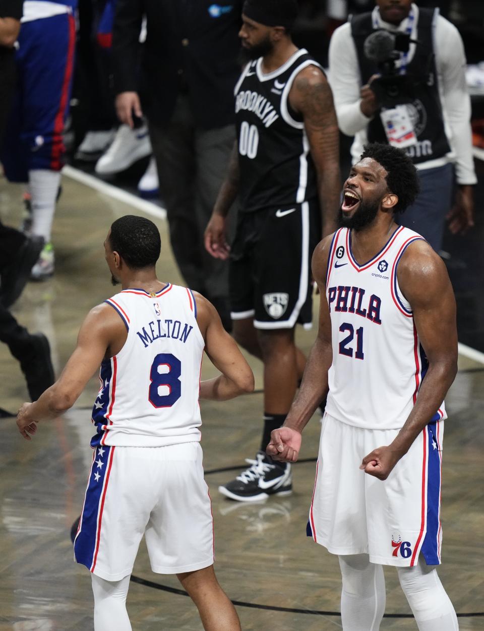 Philadelphia 76ers' Joel Embiid (21) celebrates with De'Anthony Melton (8) after the team's 102-97 win over the Brooklyn Nets in Game 3 of an NBA basketball first-round playoff series Thursday, April 20, 2023, in New York. (AP Photo/Frank Franklin II)