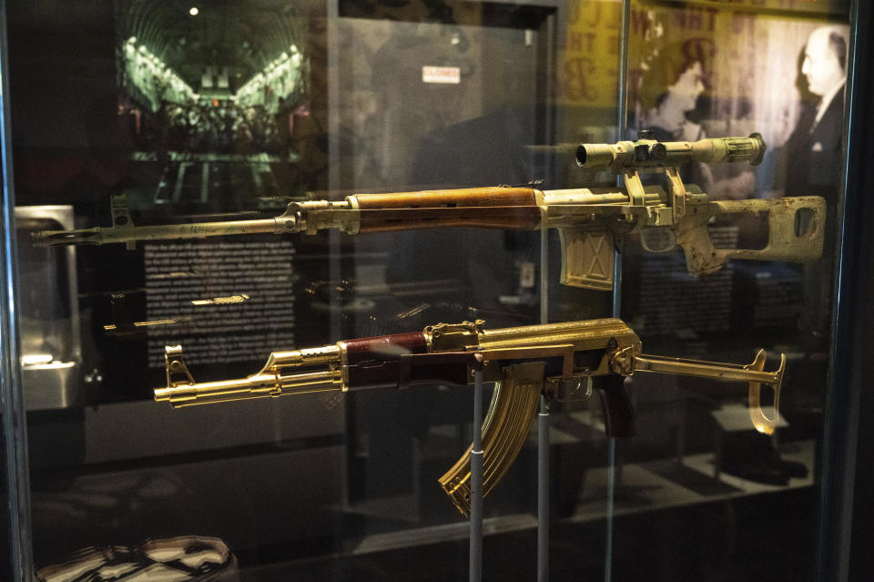 A gold AK-47 that belonged to Saddam Hussein along with an Iraqi sniper rifle is on display at the Central Intelligence Agency headquarters building's refurbished museum in Langley, Va., on Saturday, Sept. 24, 2022. (AP Photo/Kevin Wolf)