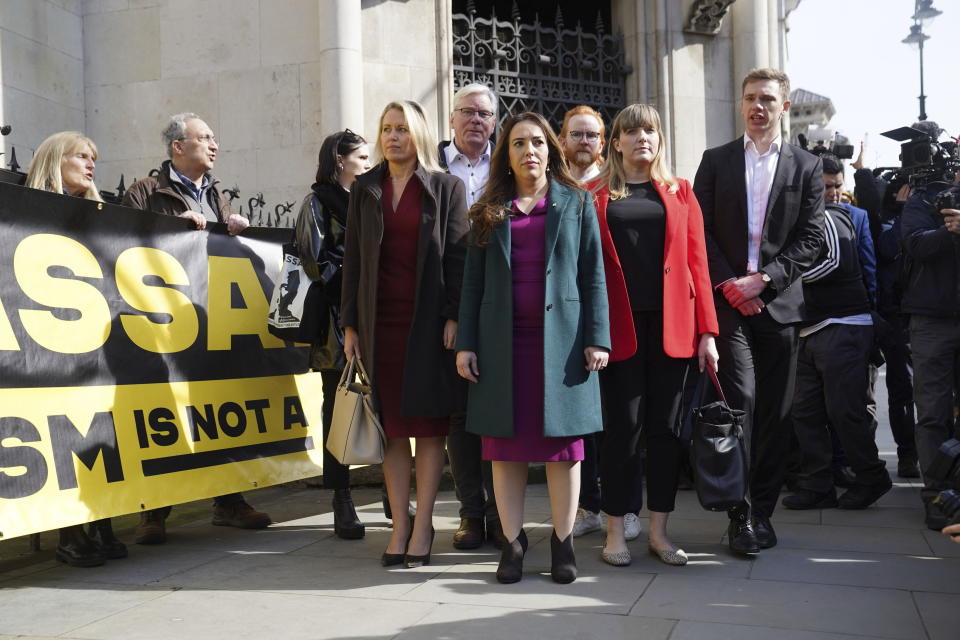 Wife of Julian Assange, Stella Assange, centre, stands outside the Royal Courts of Justice in London, ahead of the decision on whether the WikiLeaks founder's final UK bid to bring an appeal over his extradition to the United States can go ahead, on Tuesday March 26, 2024. Mr Assange faces a further wait to find out whether he can bring an appeal against his extradition to the United States after judges at the High Court adjourned their decision. (Stefan Rousseau/PA via AP)