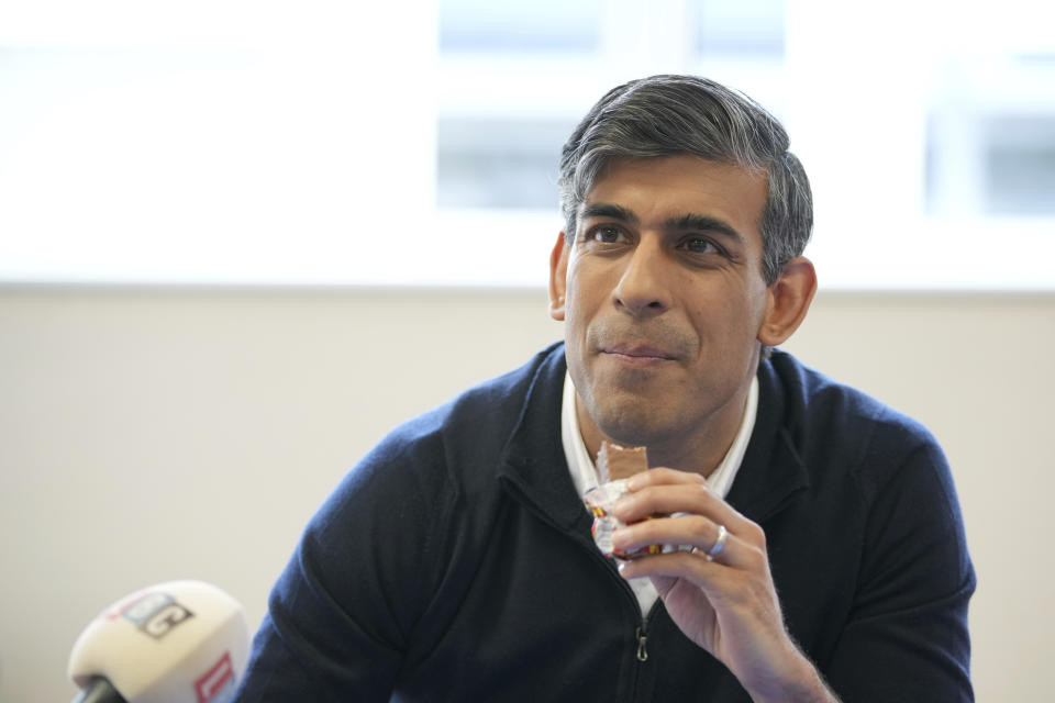 Britain's Prime Minister Rishi Sunak listens to a question from a radio journalist during an election campaign visit to the Holy Trinity Rosehill CofE Primary school in Teeside, northeast England, Friday, June 28, 2024. (AP Photo/Kin Cheung, Pool)