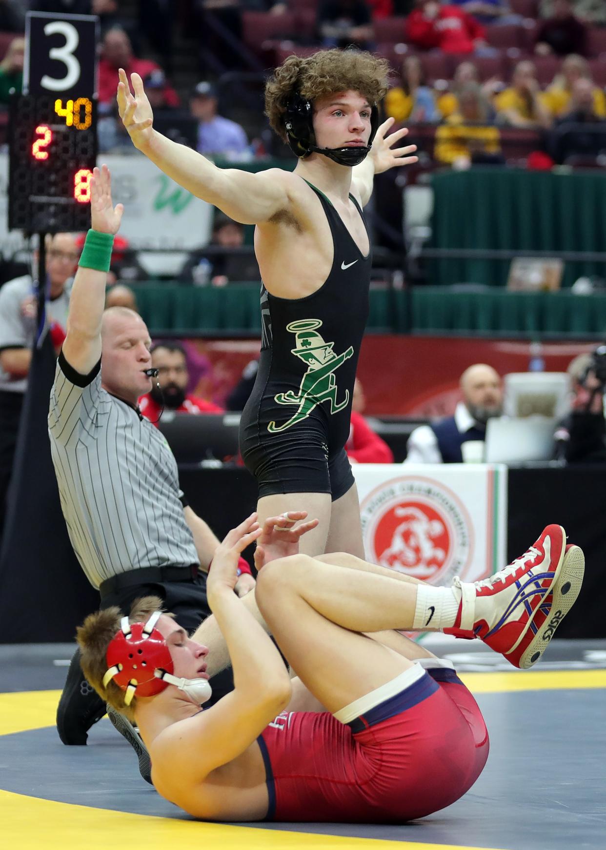 Bryce Skinner of STVM, top, celebrates after winning the state title at last year's OHSAA state wrestling tournament.